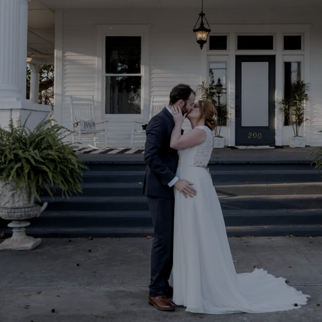 Bride and Groom Kissing in front of Main House
